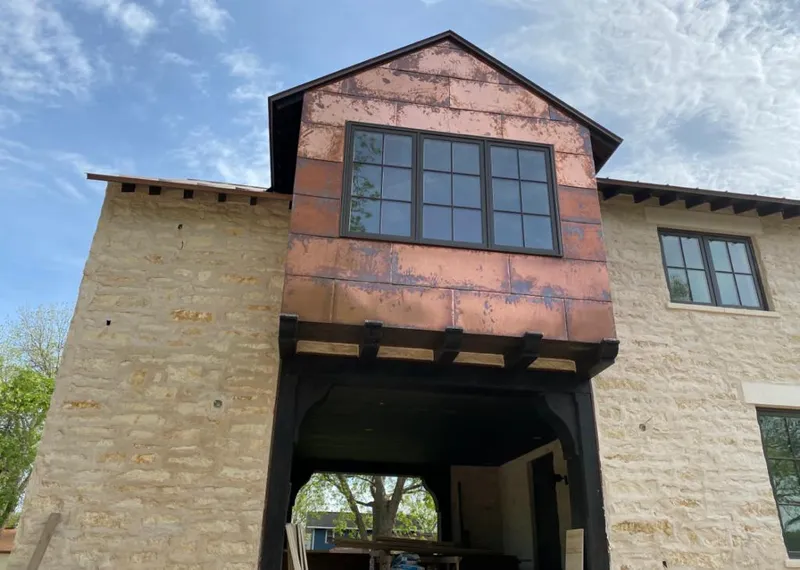 Copper metal panel facade on a stone building for Skylight Installation in West Pleasant View